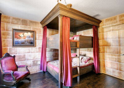 wizards way red and gold, courage and bravery castle room with large bunk bed with two double twin beds